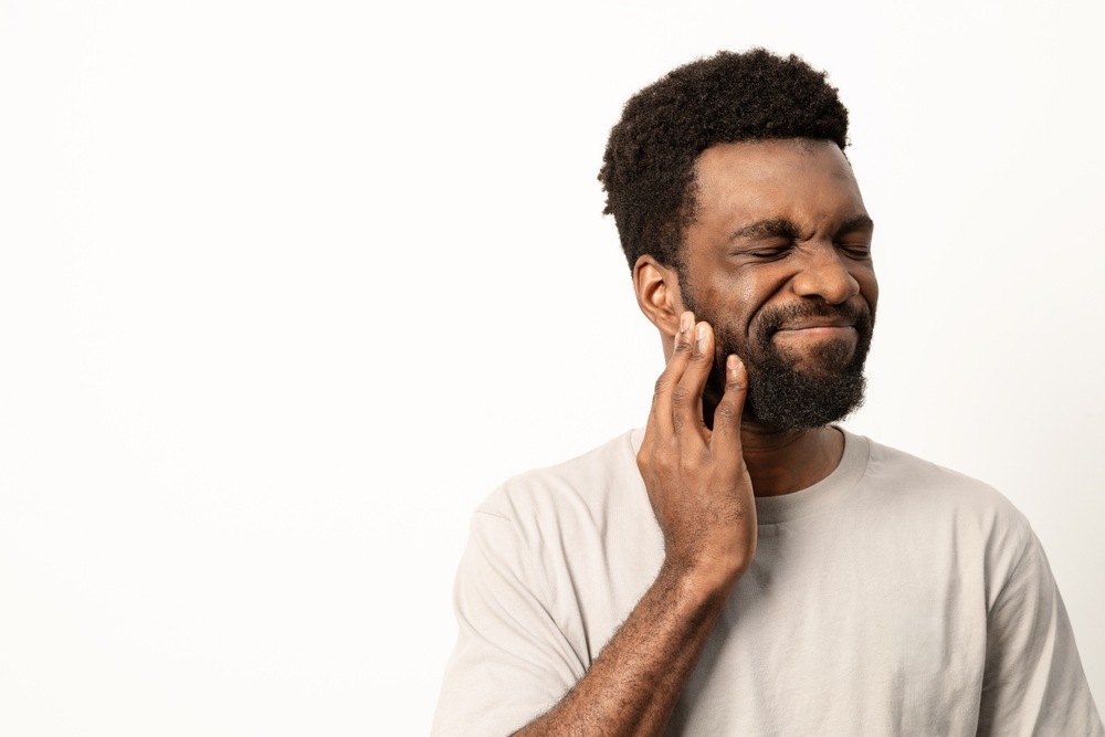 A dentist performing wisdom tooth extraction on a patient in a modern dental clinic.